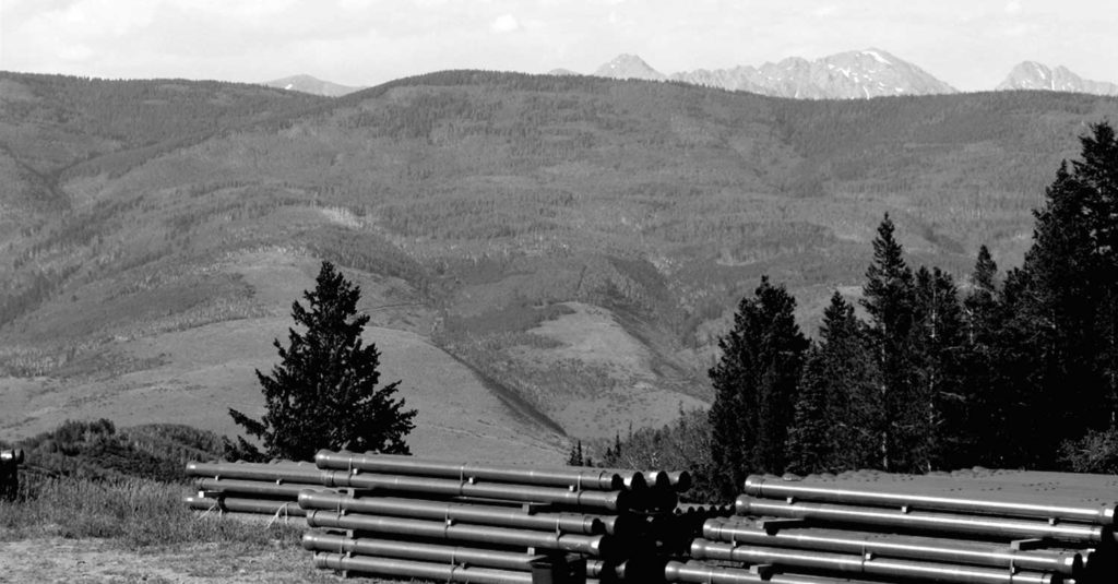 mountains scene with pipes in the foreground