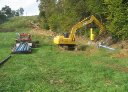 pipe being installed with construction vehicle