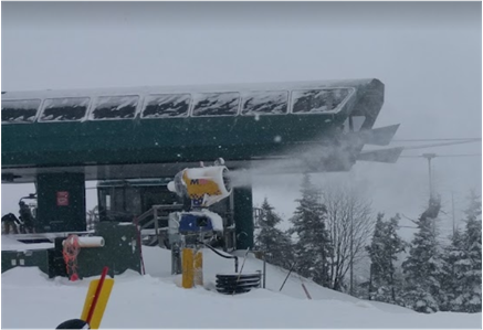 snowmaking machine blowing snow at mountain