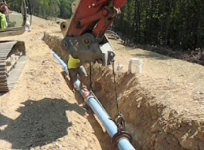 pipe being installed with construction vehicle